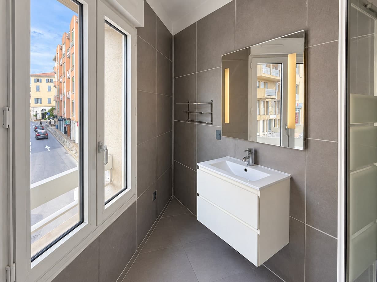 Espace vasque et fenêtre dans une salle d’eau de l’appartement